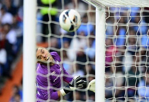 Celta's goalkeeper Sergio Alvarez eyes the ball as Real Madrid's forward Gonzalo Higuain scores